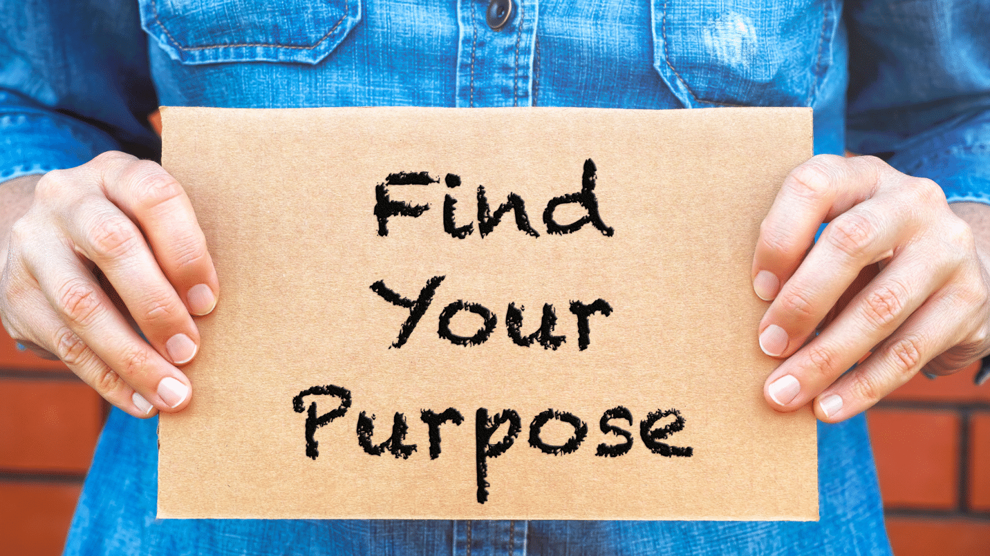 Picture of a cardboard sign with the words find your purpose to illustrate finding purpose in real estate investing