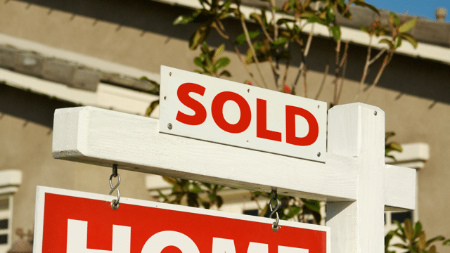 Real estate 'Sold' sign in front of a house, symbolizing the impact of the B.C. flipping tax on the housing market