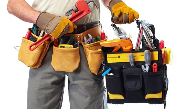 Construction worker with a fully equipped tool belt, ready for a home renovation project.