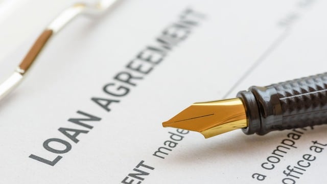 Fountain pen on a 'Loan Agreement' document, highlighting the paperwork involved in the Private Lending Checklist
