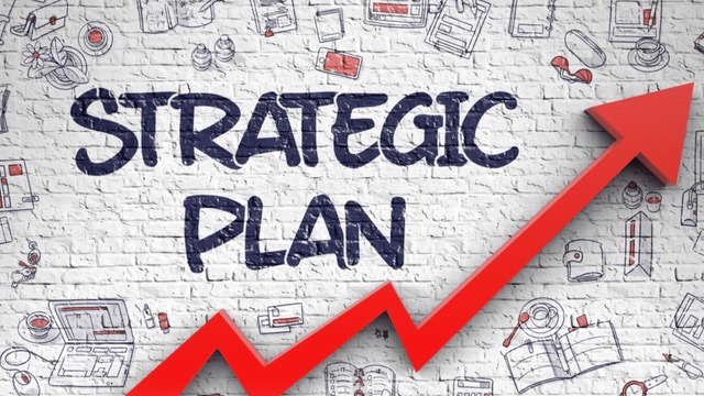 "Strategic Plan" text with a rising red arrow on a white brick wall, representing growth in a real estate investing business plan