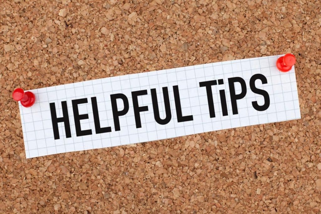 A corkboard with a piece of graph paper pinned to it. The paper has the words "HELPFUL TIPS" printed in bold black letters, offering practical advice or guidance. This image relates to providing useful tips for dealing with problem tenants